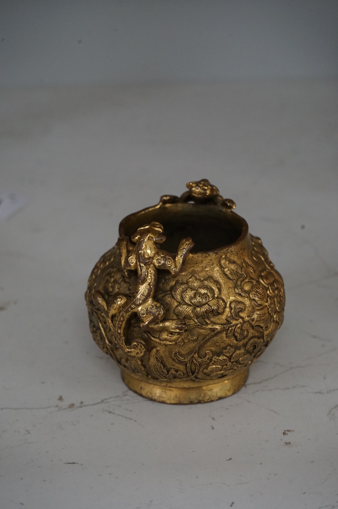 A Chinese gilt bronze vase decorated with applied lion dogs, 7.5cm high